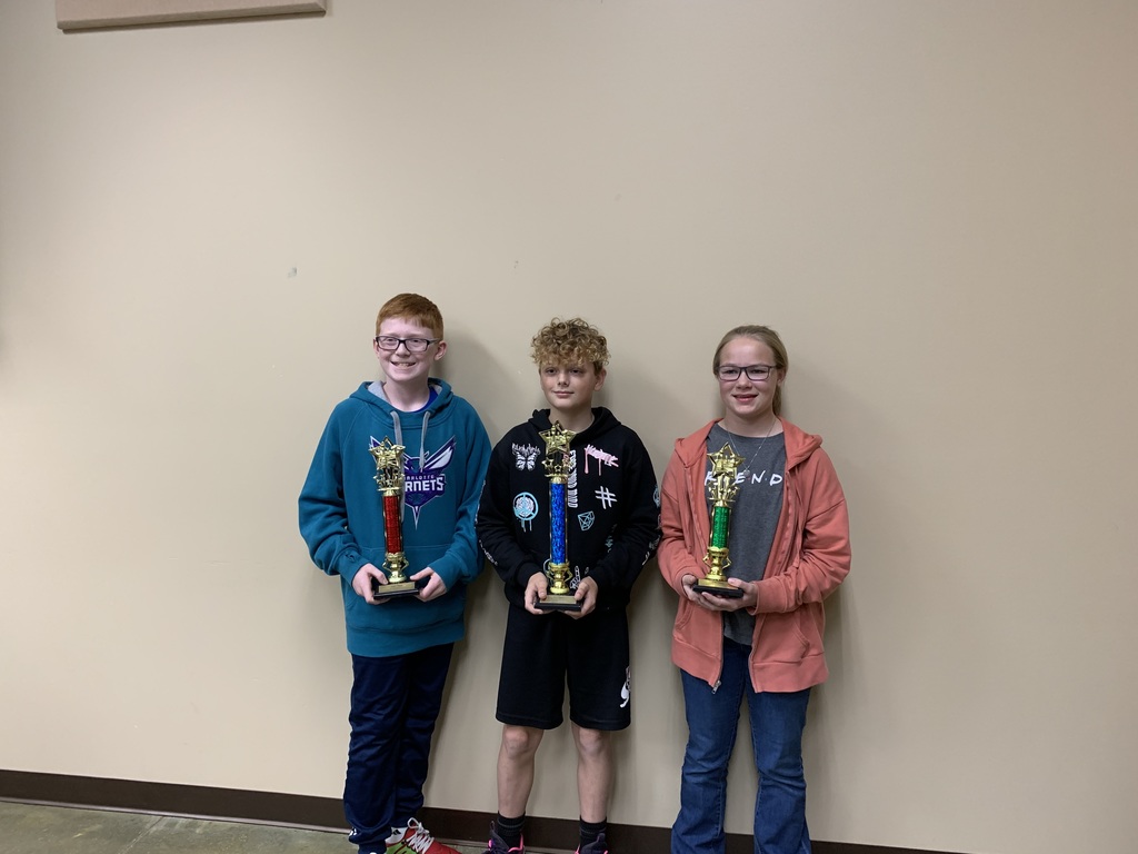 chess winners with their trophies